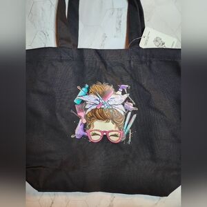 Chic Black Tote with Vibrant Hair Tools Design